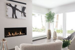 Valor L1 linear gas fireplace with rock and shale media in a bright living room