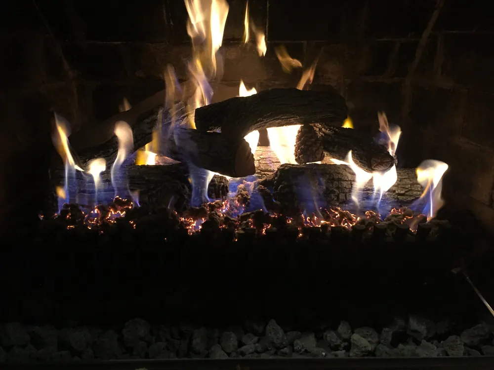 A gas log set burning after dark