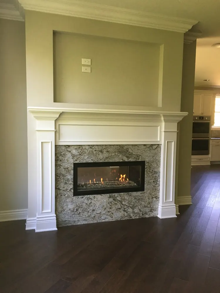 A gas fireplace installed by our crew, with the fire burning