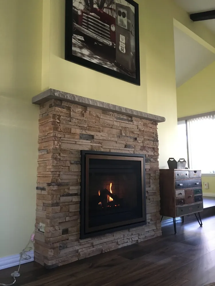A gas fireplace installed by our crew, with the fire burning