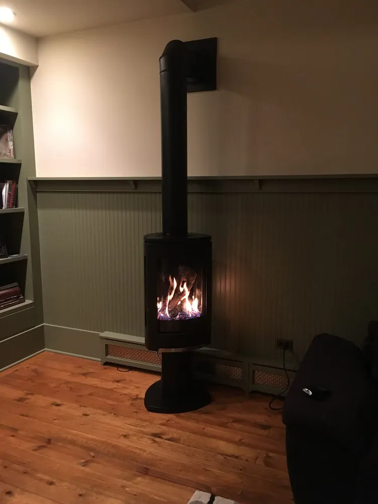A gas fireplace installed by our crew, with the fire burning